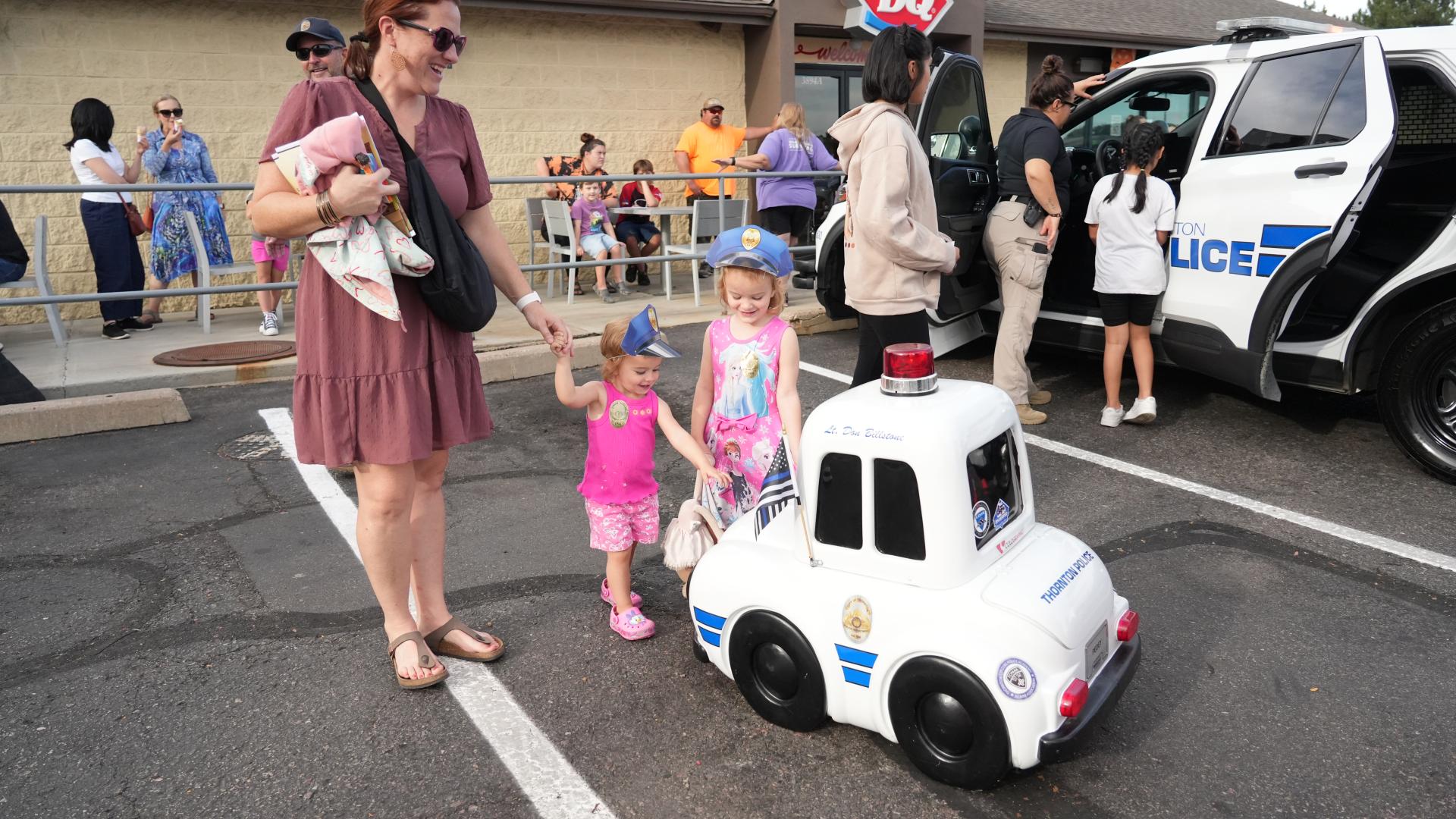 officers and families at Dairy Queen with police cars