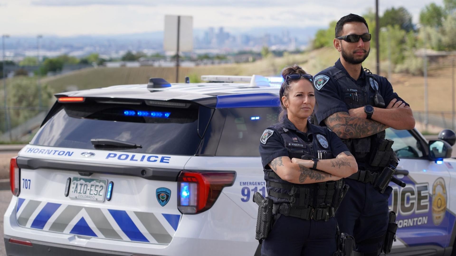 Patrol officers standing in front of patrol car