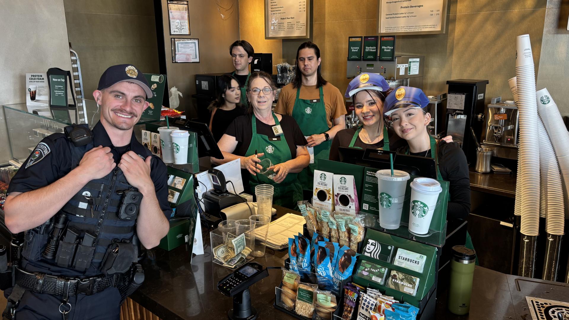 officer with Starbucks staff