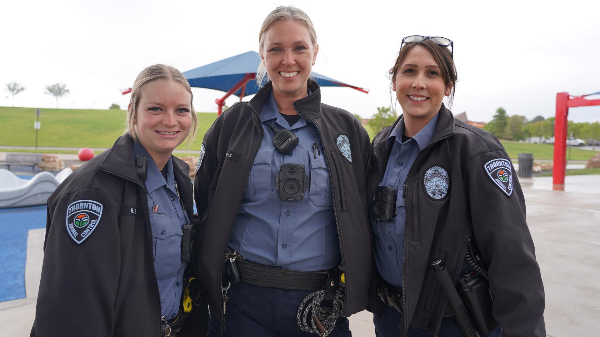 Animal control officers smiling at the camera
