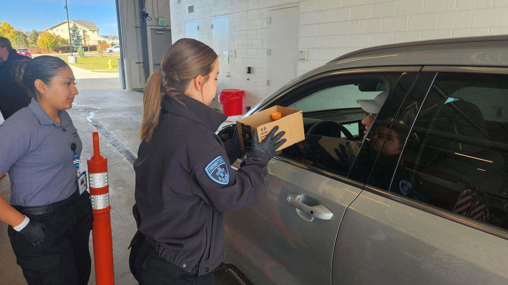 Thornton Police Explorer taking prescription drugs from the driver of a vehicle during the drug take-back drive thru event