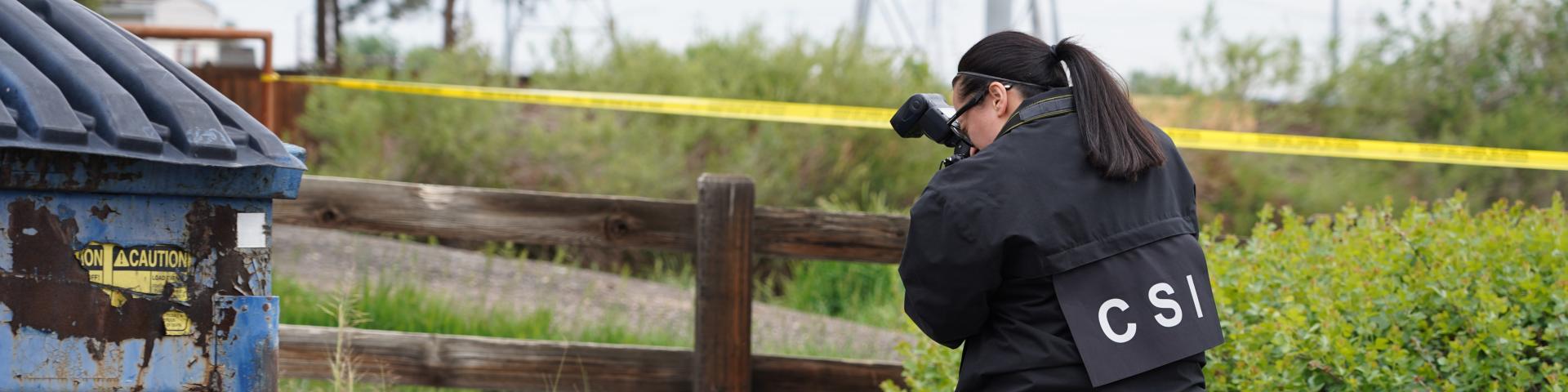 Crime scene investigator taking photos