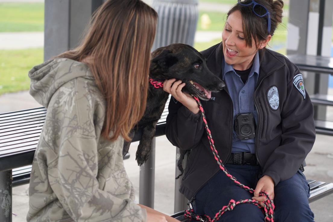 Animal control officer with dog and resident