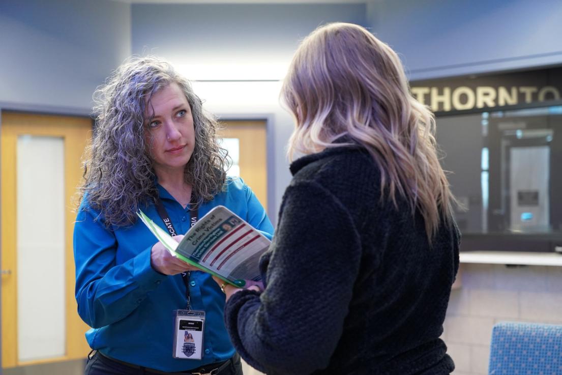Victim advocate speaking with resident
