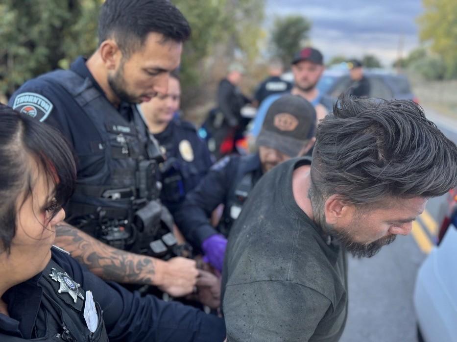 Officers placing suspect in handcuffs
